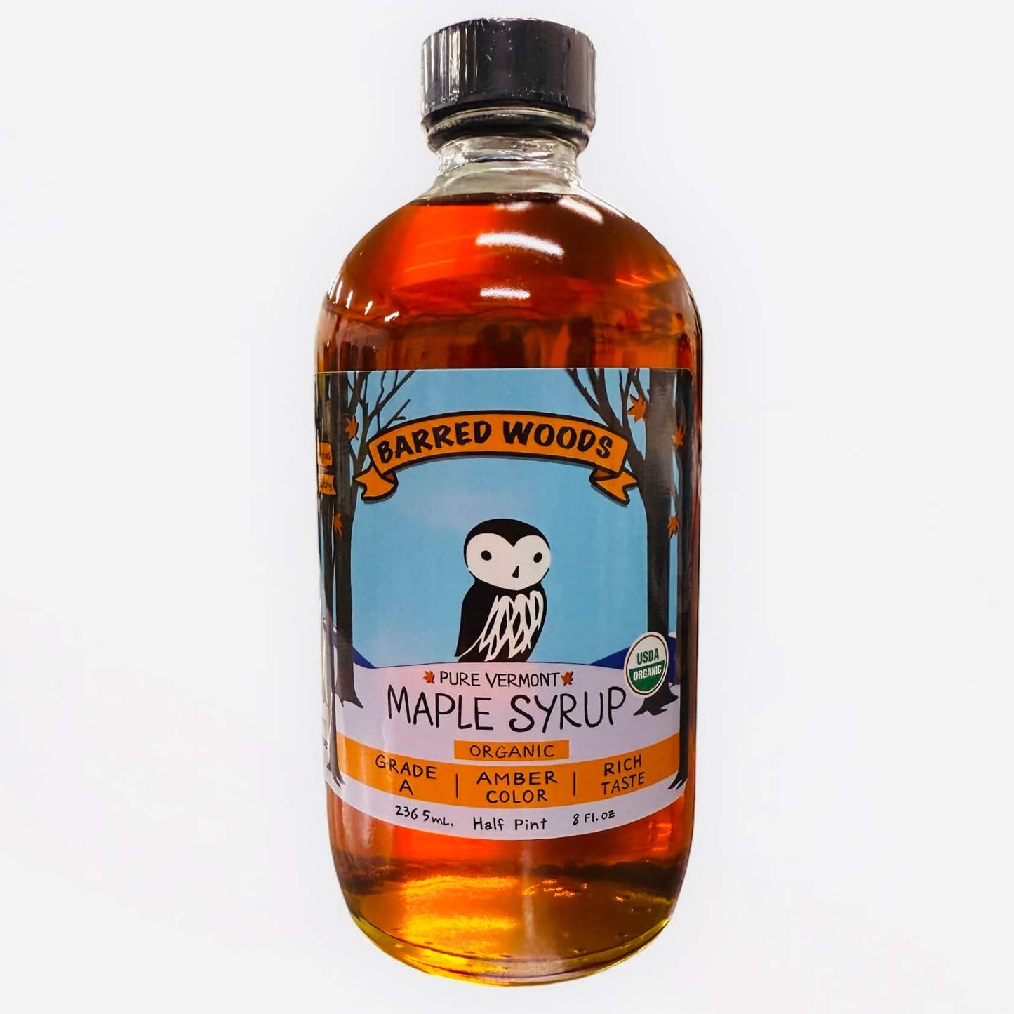 A bottle of pure maple syrup produced by Barred Woods Maple.