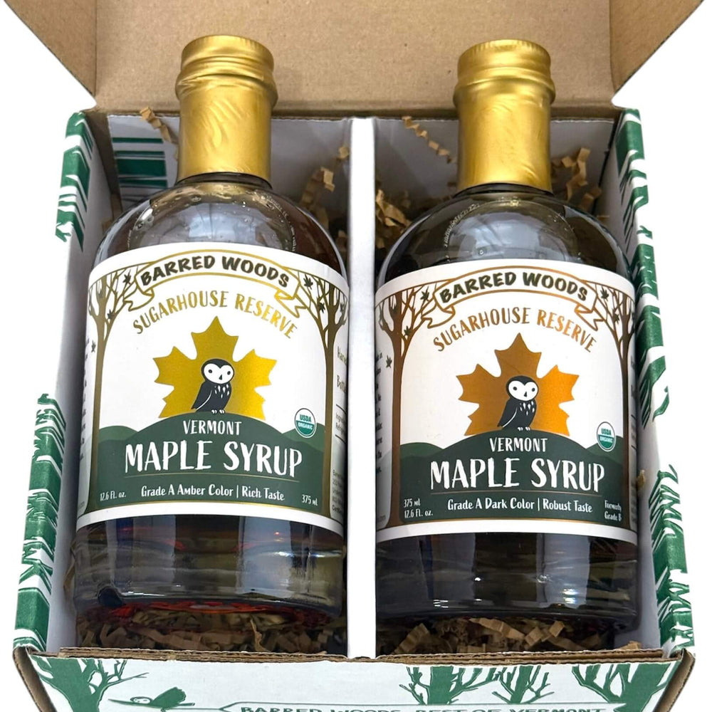Two bottles of Pure Organic Vermont Maple Syrup in a branded box with 'Barred Woods Sugarhouse Reserve' label.