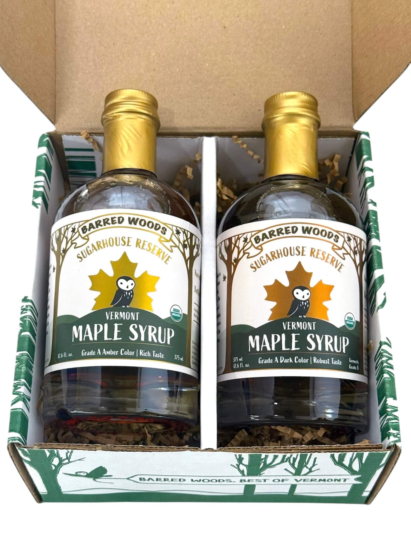 Two bottles of Pure Organic Vermont Maple Syrup in a branded box with 'Barred Woods Sugarhouse Reserve' label.