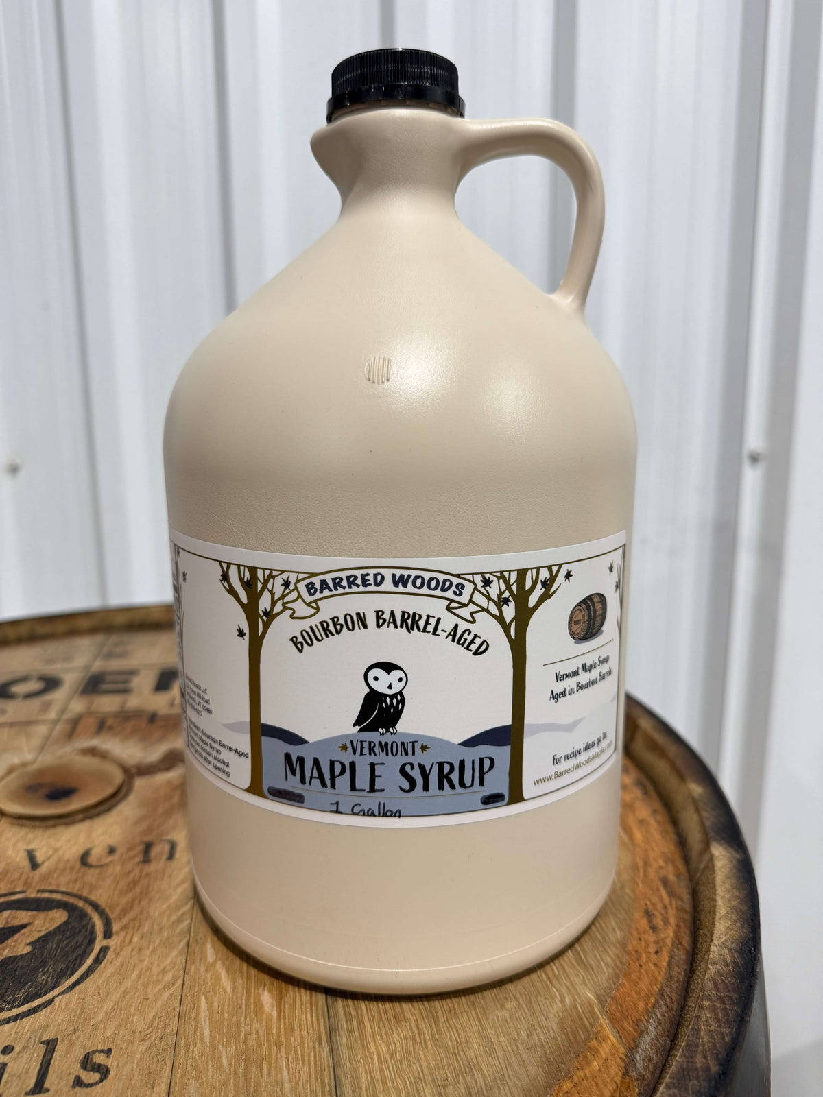A one gallon jug of bulk bourbon barrel aged maple syrup.
