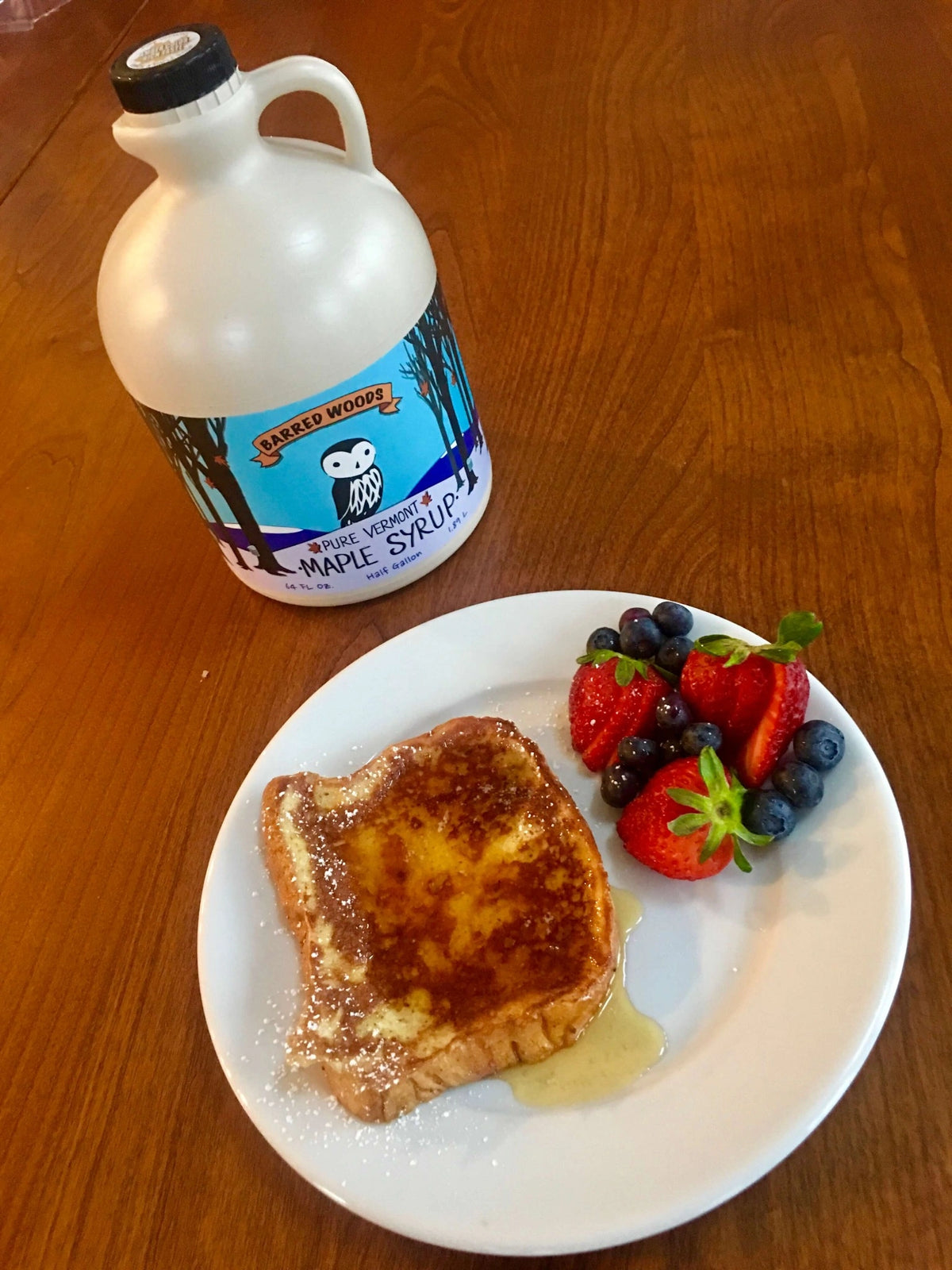 French toast with Vermont grade b maple syrup, fresh strawberries and blueberries, Barred Woods Maple half-gallon jug.