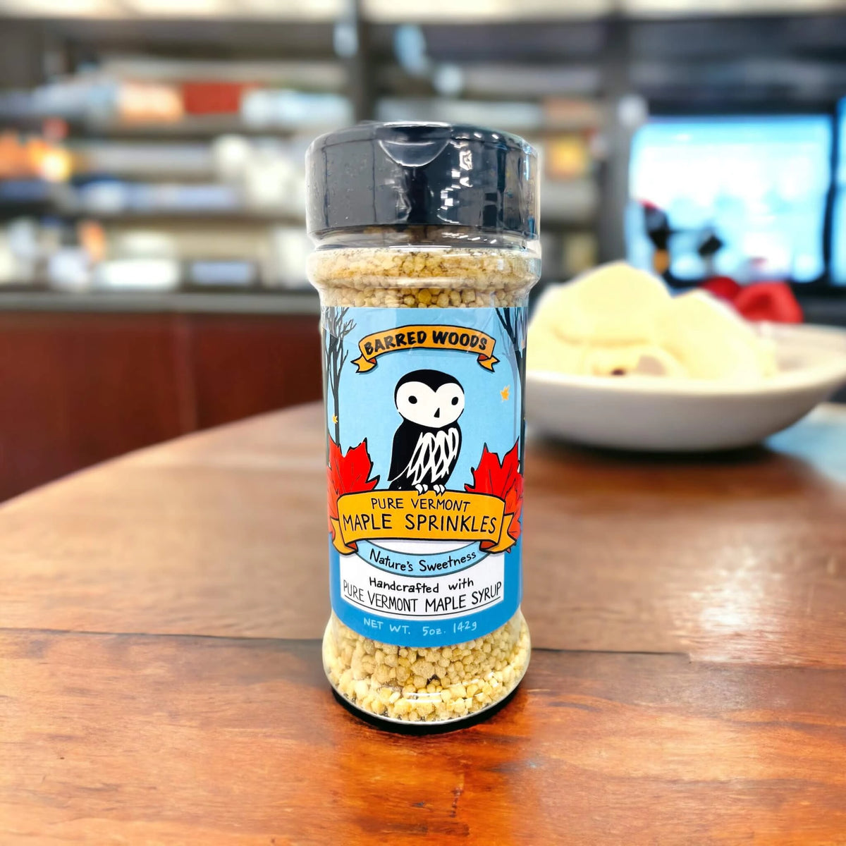 Maple sprinkles by a bowl of ice cream.  Our sprinkles make the perfect ice cream topping. 